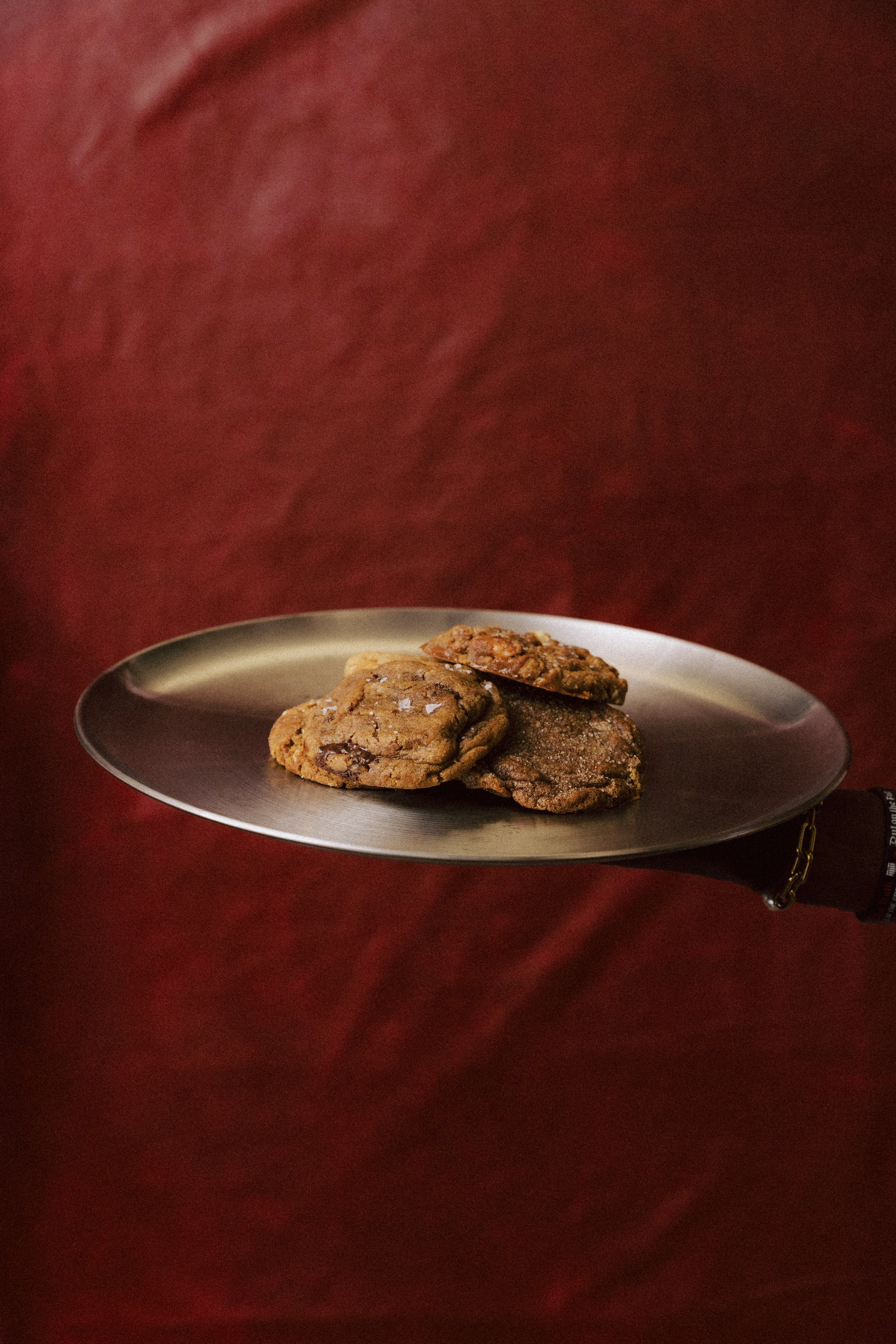 Ring & Robe cookies on a silver tray against deep red
